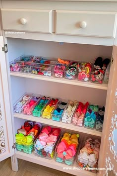 a white shelf filled with lots of colorful items