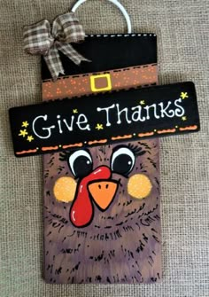 a wooden sign that says give thanks with a turkey on it