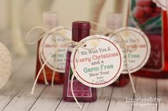 three bottles of merry christmas and a germ free new year gift on a wooden table