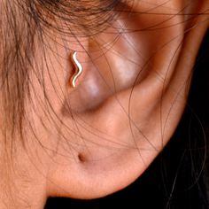 a woman's ear is shown with a small white object in the middle