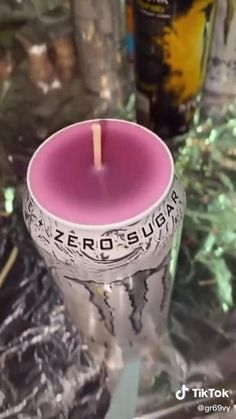 a pink candle sitting on top of a table