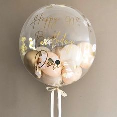 a clear balloon filled with lots of balloons that say happy 90th birthday on it