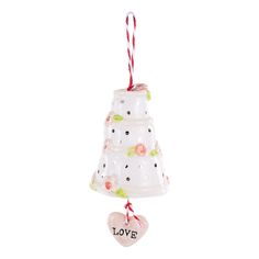 a glass ornament with a heart hanging from it's side on a white background