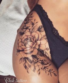 a woman's stomach with flowers and leaves on it