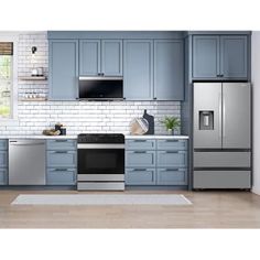 a kitchen with blue cabinets and stainless steel appliances