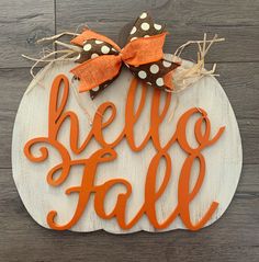 a wooden sign that says hello fall on top of a wood board with a bow