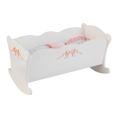 a white toy bed with pink sheets on the top and bottom, sitting in front of a white background