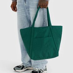 A dark green nylon tote bag with two hand straps and a front pocket. Bag Of Oranges, Eco Hair, Golden Family, Wallpaper Stores, Cloud Bag, Curated Gift Boxes, Lightweight Bag, Hair Shop, Kids Art Prints