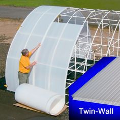 a man standing next to a large white structure