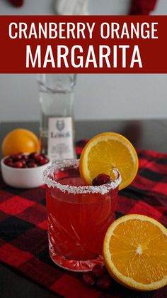 a cranberry orange margarita is garnished with sugar and garnish