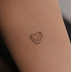 a small tattoo on the back of a woman's leg, with a piece of meat in it