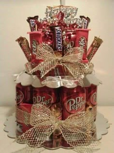 a cake made out of cans and wrapped in ribbon