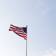 an american flag is flying in the wind