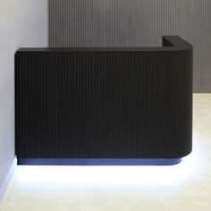 a black and white reception desk with lights