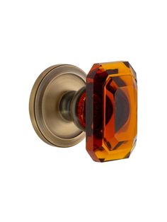 an orange glass door knob on a white background