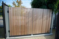 an open gate with wooden slats on the sides and metal bars at the top