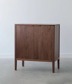 a wooden cabinet with two doors on one side