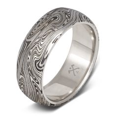 a wedding ring with an intricate design on the outside and inside, in white gold