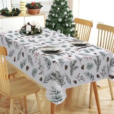 a dining room table with pine cones and plates on it