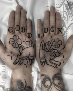 two hands that have tattoos on them with the words good luck and lucky written in black ink