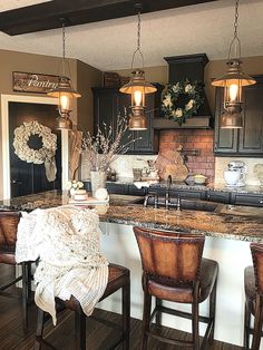 a large kitchen with an island and bar stools next to the stove top oven