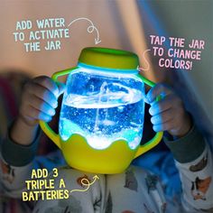 a young child holding up a glowing jar with water inside and instructions on how to use it