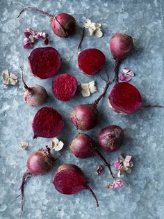 some beets are laying on the ground with their stems still attached to them,