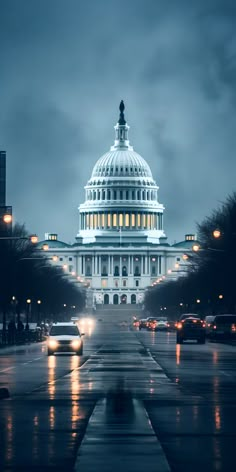 the u s capitol building at night with cars driving by in the rain, washington d c