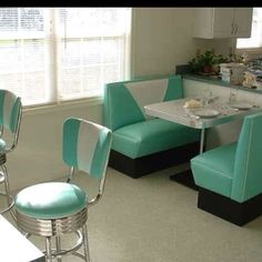 a kitchen filled with lots of blue chairs and counter top space next to a breakfast nook