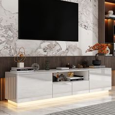 a large television mounted on the side of a white cabinet in a room with marble walls and flooring