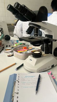 a microscope and some papers on a table