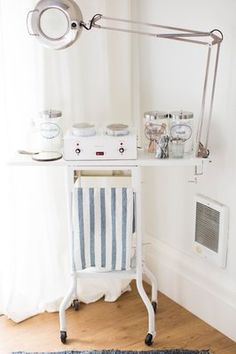 a white table with a blue and white chair next to it on top of a wooden floor