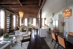 a living room filled with furniture and lots of windows