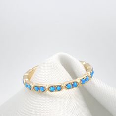 "Opal Eternity Gold ring set with 18 Real Dark Blue opal gem stones. Stunning 18 stone ring with a delicate handmade texture all around the stones. Beautifully Set with Dark Blue Opals and ready to wear alone or as a stacking ring. The back of the ring is Made of a straight line, This allows me to resize the rings quickly and should be inside your palm when you wear this Eternity ring. Lovely Everyday ring with Presence, Elegance and sheer beauty. Perfect for Stacking together with Another ident Adjustable Stackable Rings With Gemstone Accents, Opal Gemstone Stackable Rings For Anniversary, Fine Jewelry Stackable Opal Ring With Round Band, Elegant Adjustable Opal Stackable Rings, Stackable Opal Ring Jewelry, Stackable Opal Birthstone Ring For Promise, Stackable Opal Birthstone Promise Ring, Adjustable Opal Stackable Rings, Stackable Round Opal Promise Ring