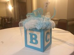 a blue and white box with the letter b on it sitting on a round table