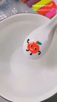 a spoon with a cartoon crab on it