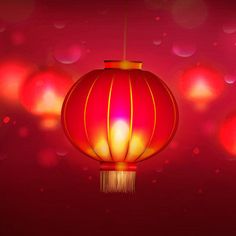 a red chinese lantern hanging in the air with boket lights behind it on a pink background