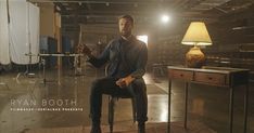 a man sitting on top of a chair in a room