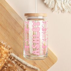 a mason jar with the word sassy printed on it next to a tassell