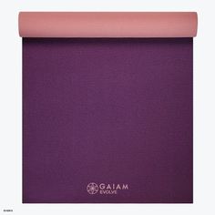 the yoga mat is shown in purple and has a light pink border on top of it