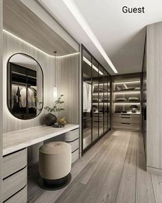 a walk - in closet with dressing area and mirror on the wall next to it