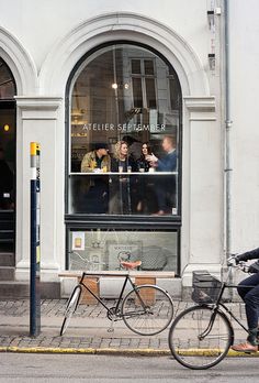 a bicycle parked in front of a store window