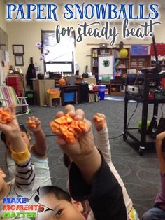 several children are holding up small pieces of food