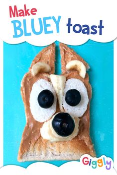 a toast with peanut butter and blueberries on it that looks like a dog's face