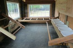 the inside of a house being built with wooden beams and bowls in it's storage area