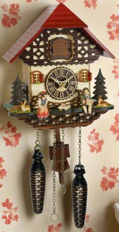 a cuckoo clock hanging from the side of a wall