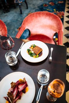 a table topped with plates and glasses filled with food