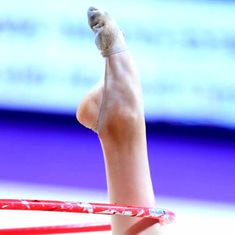 a close up of a person's legs and feet in the air above a wrestling ring