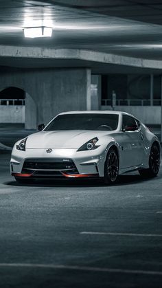 a silver sports car parked in a parking garage