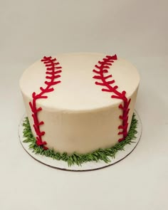 a baseball cake with red stitches on it